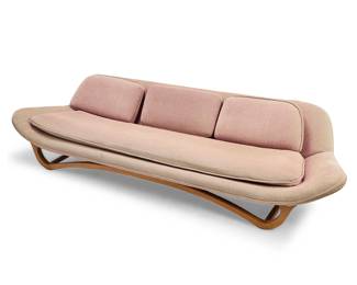 2032 In the style of Adrian Pearsall (1925-2011) A Modern three-seater sofa, late 20th century Later reupholstered in a pink cotton fabric, raised on a bentwood biomorphic frame Unmarked Height 26 1/4 in., width 107 in., depth 38 in. Estimate: $1,000 - $2,000