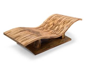 2156 Janet Polizzi (b. 20th century) A 'Flying Carpet' chaise lounge, circa 1997 With near-book matched exotic wood veneer Unmarked Height 22 1/4 in., width 72 1/2 in., depth 30 1/4 in. Estimate: $1,200 - $1,800