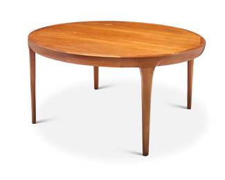 2142 Ib Kofod-Larsen (1921-2003) A Modern teak extension dining table, mid-20th century Circular at its smallest, with three extension leaves, raised on attenuated legs Unmarked Height 28 1/2 in., diameter 55 in., width of each extension 19 3/4 in. Estimate: $1,000 - $1,500