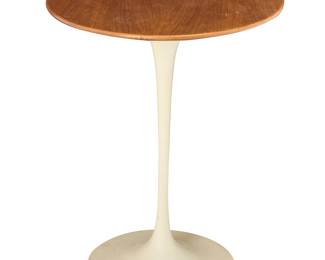 2011 Eero Saarinen (1910-1961) A 'Tulip' side table for Knoll Associates, late 20th century The circular wood top raised on an enameled steel base With applied factory label Height 20 1/2 in., diameter 16 in. Estimate: $400 - $600