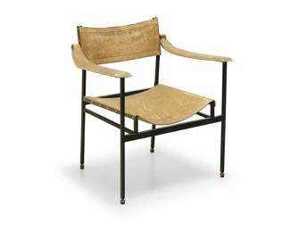 2158 In the manner of Jacques Adnet (1900-1984) A Modern metal and leather armchair, mid-20th century The enameled steel frame with leather-wrapped armrests and leather sling back and seat Unmarked Height 29 in., width 25 3/4 in., depth 21 in. Estimate: $500 - $700