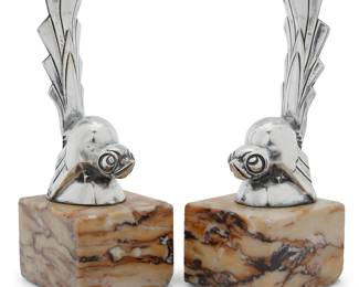 2228 Gaston Rischmann (1907-1979) A pair of Art Deco silver-plated watch stands, mid-20th century Each in the form of a bird, on marble base One marked: Rischmann / FRANCE; the other: G Rischmann / FRANCE 2 pieces Height of each overall 7 in., width 2 1/2 in., depth 2 3/4 in. Estimate: $800 - $1,200