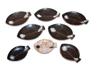 2270 Eight Lagardo Tackett & Kenji Fujita style glazed ceramic fish plates Second half 20th century With incised details, comprising five larger and three smaller in the style of similar plates designed by Lagardo Tackett (1911-1984) & Kenji Fujita (1911-1992) during Kenji's brief stint at Tackett Associates Each unmarked 8 pieces Height of each larger 1 1/2 in., width 10 7/8 in., depth 8 in.; smaller width 8 1/8 in., depth 6 1/4 in. approximately Estimate: $400 - $600