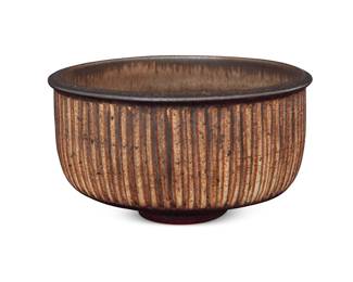2202 Harrison McIntosh (1914-2016) A glazed stoneware bowl, mid-20th century With brown and black glazes and carved lines Impressed with potter's chop mark: HM; applied paper label to the underside: Handthrown Stoneware / Harrison McIntosh / Claremont / California; with artist's applied paper label and inventory number: #66257 Height 3 in., diameter 5 1/2 in. Estimate: $500 - $700