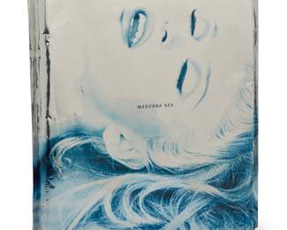 2236 "Madonna - Sex" 1992 Hardcover book and CD Metsel, Steven (photography). "Sex." Essay by Arthur C. Danto. New York: Warner Books, 1992 In collaboration with the Robert Mapplethorpe Foundation, the ring-bound book with metal boards, including a CD copy of Madonna's "Erotica" album, sealed in original Mylar packaging Height 15 in., width 11 3/4 in., depth 3/4 in. Estimate: $600 - $800