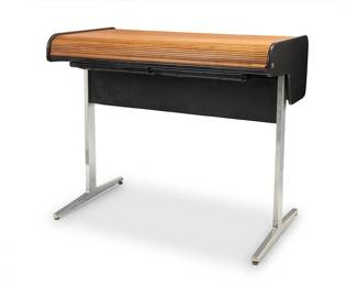 2244 George Nelson (1908-1986) & Robert Propst (1921-2000) An 'Action Office' Series II desk for Herman Miller, 1968-1975 Series II designed 1968 The roll-top desk with locking walnut tambour opening to reveal a laminated wood writing surface with sliding plastic compartment drawers, raised on a chromed metal base Unmarked Height 46 1/2 in., width 54 in., depth 30 in. Estimate: $1,200 - $1,800
