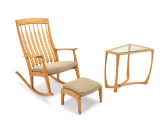 2215 Randy Bader (20th Century) A Contemporary rocking chair, footstool, and side table, late 20th/early 20th century Comprising a spindle-back rocking chair with matching footstool, each with upholstered cushion, and a glass-top trapezoidal side table Chair etched with signature and date: Randy Bader woodworking 4-6-1996; table also signed and dated: 3-3-2006; chair and footstool each with tag: Burger Quality Upholstery 3 pieces Height of chair 41 1/4 in., width 28 3/4 in., depth 46 1/4 in.; height of ottoman 12 1/4 in.; height of side table 24 1/4 in., width 29 in., depth 20 1/4 in. Estimate: $1,000 - $1,500
