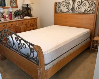 Lexington fine oak queen bed with ornamental iron scroll work on the head and foot board, complete with mattress and foundation 
