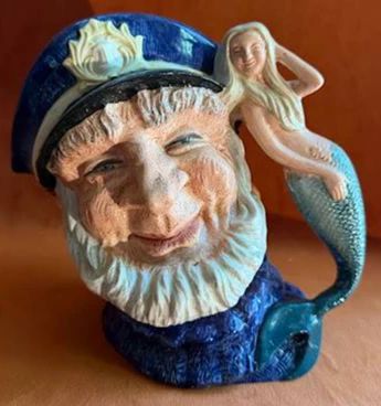 Royal Doulton character jug titled "Old Salt," model D6551. Features a sailor with a blue cap and beard, with a mermaid as the handle. Marked with Royal Doulton stamp and copyright 1960.