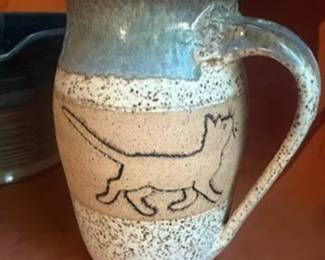 Studio pottery lot including a signed pitcher with cat motif by Kreitner, a mixing bowl by Jacob King (Lancaster County, PA, dated 2014), a handled bowl, and a small blue glazed vessel. 