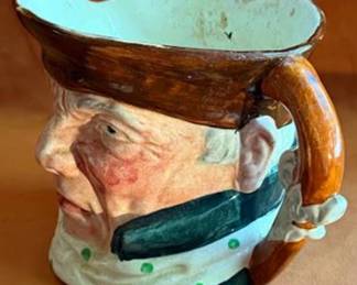 Lancaster & Sandland Ltd handpainted ceramic character jug featuring "The Highwayman." This English ware, made in England, displays a detailed face with polka dot scarf and tricorn hat. Marked on base.