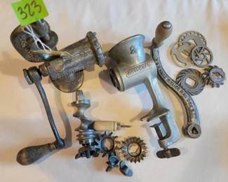 Universal No. 2 cast iron meat grinder, marked by L.F. & C., Meriden, Conn., U.S.A. Includes various attachments and gears for different grinding functions. Designed for table mounting using a clamp mechanism.