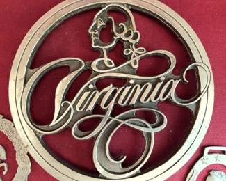 Cast pewter plaques and trivets by Fischer Pewter, Richmond, VA. Includes Virginia-themed designs, portraits of Lee and Jackson, figures on horseback, and script "Virginia" trivet. Some items marked "Virginia Heritage Collection."