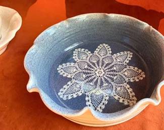 Signed, handmade ceramic bowl with blue glaze and lace pattern dated 4/17/95, and a matching cream pottery pitcher and basin set both marked 'MCM.' The bowl features a scalloped rim and decorative interior.