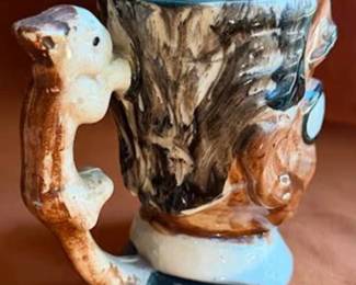 character face mugs and pitchers, each marked 'Made in Occupied Japan'. Features hand-painted details with various character designs, including a king and other distinctive faces. Produced circa 1945-1952.