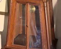 Handcrafted wooden grandfather clock built in 1962 by Marion Forth of Fort Wayne, featuring a glass-front cabinet, two lower drawers, and a Roman numeral clock face marked 'French.' Includes builder's inscription inside. 