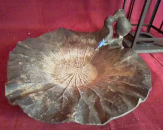 Cast metal dish shaped as a lotus leaf with two bird figures on the rim, marked 'Handcrafted Lotus Leaf.' Also included is a square metal lantern with glass panels and a hinged top. Both items show visible surface wear and oxidation.
