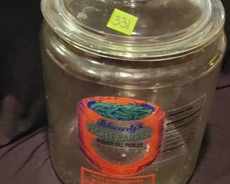 Clear glass jar with lid featuring "Schwartz's Pickle Barrel Kosher Dill Pickles" label. The jar measures approximately 13 inches tall. Includes original label and nutritional facts. Suitable for display or storage purposes.