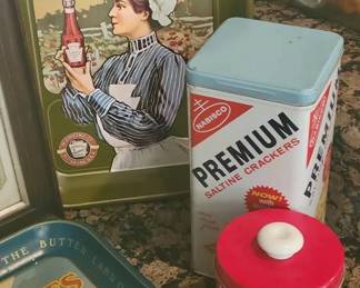 Advertising tins and trays: Hershey's Kisses, Land O'Lakes, Barnum's Animals, Premium Crackers, Lipton Tea, Heinz, and a framed Kellogg's sign. Dimensions of Kellogg's frame are about 15x19 inches. Includes a Hershey's Kiss skiing keychain.