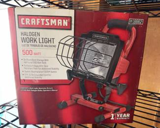 CRAFTSMAN halogen work light with a 500 watt capacity and portable H base, featuring an easy access hinged fixture, steel light guard, and 5 ft. 18/3 grounded cord. New in original box, bulb not included. Single unit as shown.