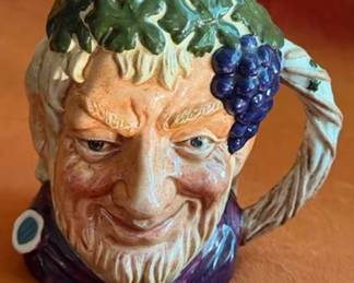 Royal Doulton ceramic character jugs including Bacchus, Granny, Drake, The Lumberjack, Long John Silver, and Captain Henry Morgan. Each jug features hand-painted details and Doulton backstamps.
