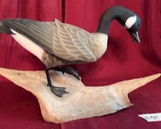 Hand-carved Canada Goose sculpture by C.J. Waterfield, featuring painted details and mounted on a natural wood base. The base is artist-signed and labeled 'Canada Goose' with a date of '1/08'.