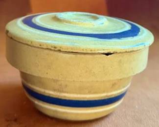 TerraWare 9.5" baking dish, a large mixing bowl with decorative banding, a small lidded jar, and a pair of blue handled stoneware candle holders. All pieces are ceramic or stoneware.