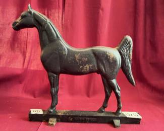 Cast iron horse figure in weathervane style with dark finish, marked 'KROK GENUI' on the base. Displays surface wear and oxidation. Suitable for display or collection. Measures approximately 10" in length.