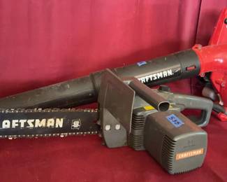 Craftsman 14-inch electric chain saw and a Craftsman B215 2-cycle 25cc gas-powered leaf blower. Both tools display visible surface wear and signs of use. Chainsaw bar measures 14 inches.