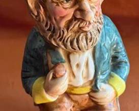 Earthenware character jug by Royal Doulton, depicting a seated bearded man with a tricorn hat. The jug features hand-painted details, and the maker's mark is stamped on the base. This piece is collectible and well-recognized in Royal Doulton series.