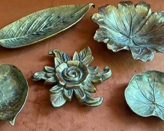 Cast solid brass decorative trays by Valerius Smith, featuring various leaf and floral shapes. Each tray shows detailed naturalistic forms and has markings on the underside.