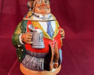 German ceramic figural beer stein shaped as a jovial man in formal attire, complete with a hinged pewter lid and marked "Germany" on the base. 