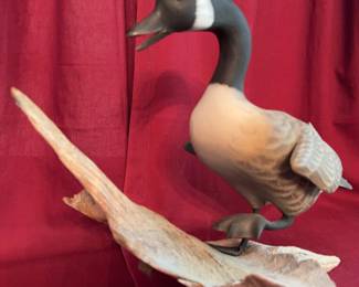 Hand-carved Canada Goose sculpture by C.J. Waterfield, featuring painted details and mounted on a natural wood base. The base is artist-signed and labeled 'Canada Goose' with a date of '1/08'.
