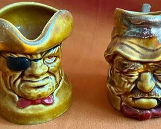 Royal Doulton ceramic character mugs: "Highwayman 97" and "Old Gaffer 94." Each features a detailed hand-painted design with individual facial expressions and distinct attire. Both are marked on the base.