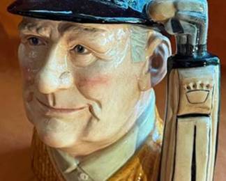 Royal Doulton ceramic character jug titled 'Golfer' D6623, modeled by David B. Biggs. Features a golfer's head with a golf bag handle. Marked Royal Doulton, dated 1970.