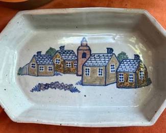 Cagle Road Pottery 1999 striped pitcher, a signed hand-painted village motif tray by Paloma, a round brown stoneware lidded casserole by RIC USA, and a small white ceramic grill pan. Each piece is individually marked by its maker.