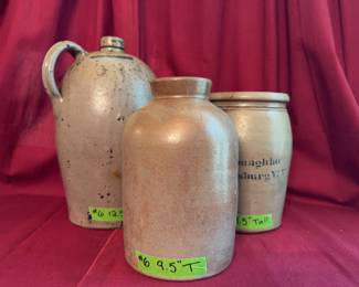 Three stoneware containers including a handled jug (12.5" tall), a wide-mouth jar with impressed seal (9.5" tall), and a crock marked A.P. Donaghho Parkersburg, W.Va. (9.5" tall).