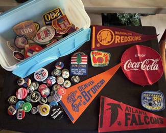 Sports-themed felt pennants, cloth patches, and pinback buttons. Includes Denver Broncos, Washington Redskins, Atlanta Falcons items, political buttons, Coca-Cola patch, and various membership and event items. 