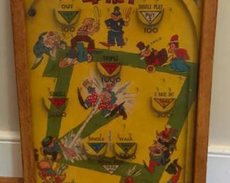 Poosh-M-Up Jr. 4-in-1 Bagatelle tabletop pinball-style game featuring colorful illustrations and labeled scoring areas. Set in a wooden frame, approximate size is 11 x 17 inches.