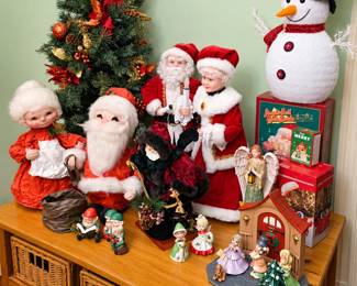 Christmas collectors will love this festive assortment! Featured items include a decorated tabletop tree, vintage-style Santa and Mrs. Claus figures, a lighted snowman, holiday dolls, angels, elves, ceramic figurines, a charming Christmas doorway scene, and boxed seasonal decorations. A wonderful selection for adding nostalgic cheer to your holiday décor!