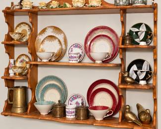 Beautiful wall-mounted wooden display shelf filled with coordinated vintage china and decorative treasures. The collection includes colorful plates, teacups and saucers, floral pieces, brass canisters, a vintage tankard, gold bird figurines, flower-shaped candleholders, and more. A wonderful mix for china collectors, vintage décor lovers, and anyone looking for unique statement pieces!