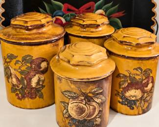 Charming vintage four-piece kitchen canister set featuring warm golden-brown tones, matching sculpted lids, and beautiful fruit designs. The naturally aged finish adds wonderful farmhouse character—perfect for kitchen storage, display, or vintage décor collectors!