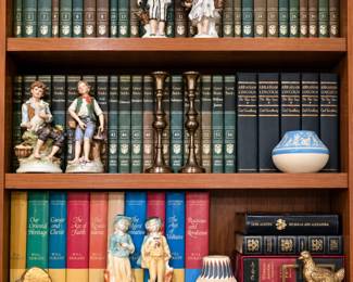 Worked for 15s  A beautiful collection for book lovers and collectors! Featured items include matching volumes from the Great Books series, Will and Ariel Durant’s Story of Civilization, an Abraham Lincoln book set, decorative collectible editions, porcelain figurines, brass candlesticks, a blue-and-white pottery vase, and additional vintage décor.