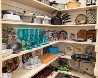 A kitchen collector’s treasure trove! This well-stocked pantry features vintage pots and pans, classic cookware, colorful turquoise goblets and tumblers, decorative and collector plates, serving dishes, bakeware, utensils, storage containers, trivets, and assorted kitchen accessories. Something for everyone—from practical everyday pieces to charming vintage finds!