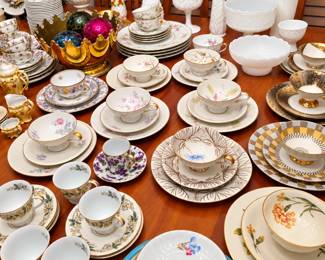 Tea lovers and collectors, this table is for you! A beautiful assortment of vintage teacups, saucers, dessert plates, bowls, and serving pieces featuring delicate florals, bold geometric designs, gold trim, and mixed patterns. Also included are elegant milk-glass vases, bowls, decorative pieces, and other charming tabletop treasures!