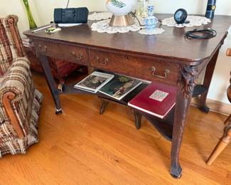 antique wooden library table or writing desk With lion head accents