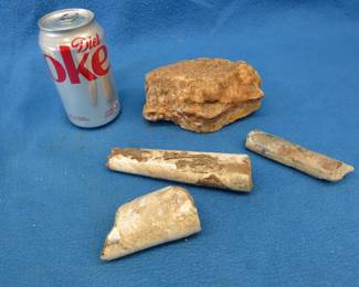 Lot 372. The large specimen is likely rough chert, flint, or a silicified /weathered sedimentary rock. The three other pieces are likely Belemnite rostra.
