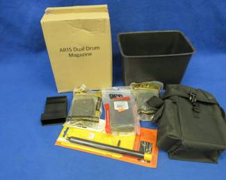 Lot 124. New in the box AR-15 Dual Drum Magazine, 10-round 5.56 magazines, a storage pouch, and more