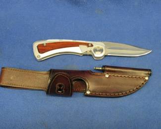 Lot 204. Leatherman fixed blade knife with a folding saw blade and sheath