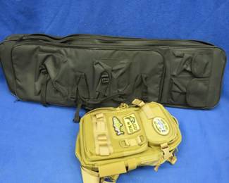 Lot 94. Soft rifle case with backpack straps and multiple storage pockets, and a sling bag with multiple storage pockets
